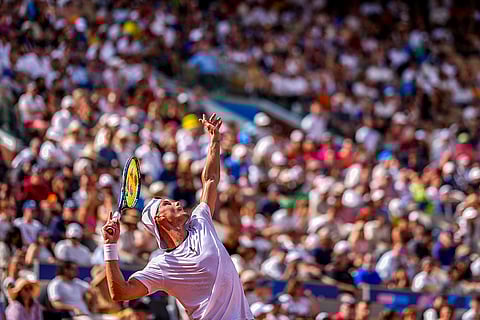 Marton Fucsovics serves against Rafael Nadal